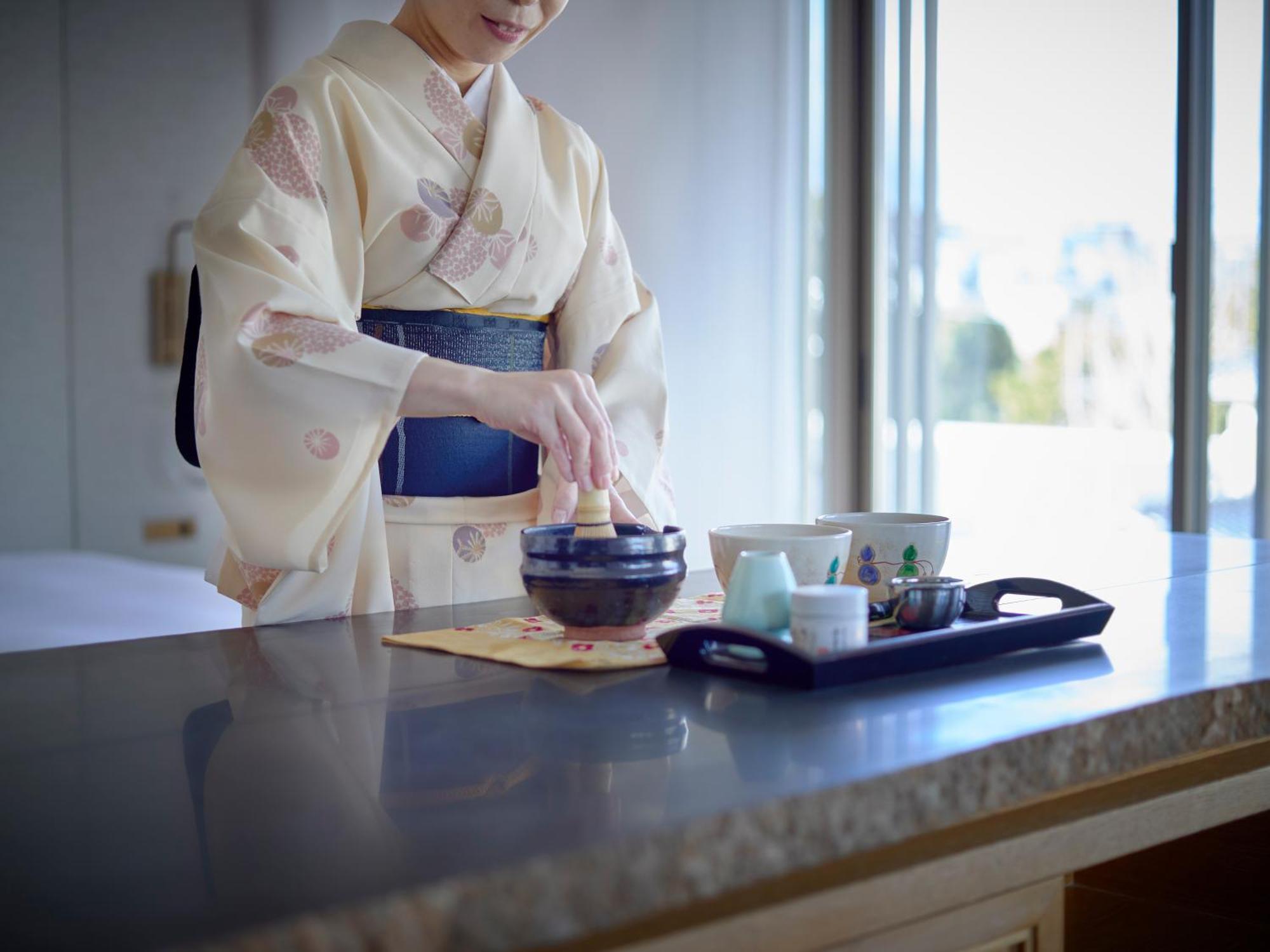 Hotel The Celestine Kyoto Gion Bagian luar foto A woman in a yukata preparing a Japanese tea ceremony